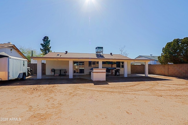 rear view of house featuring central AC and a patio area