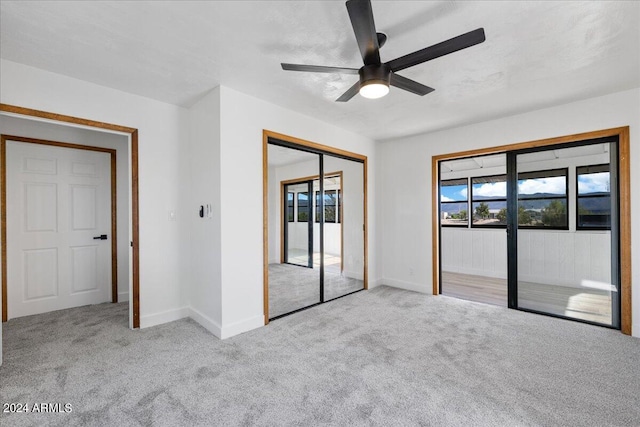 unfurnished bedroom with light colored carpet and ceiling fan