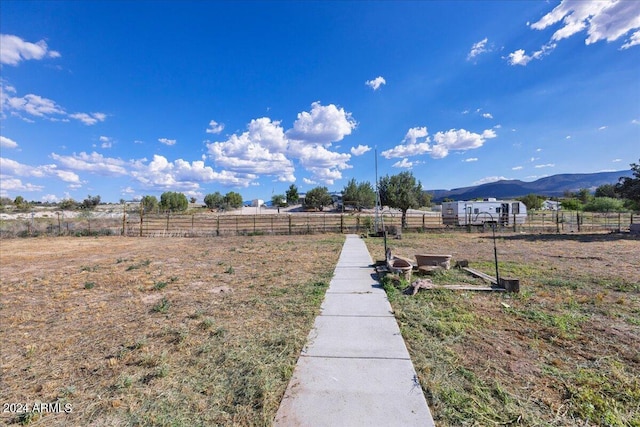 view of yard featuring a mountain view and a rural view