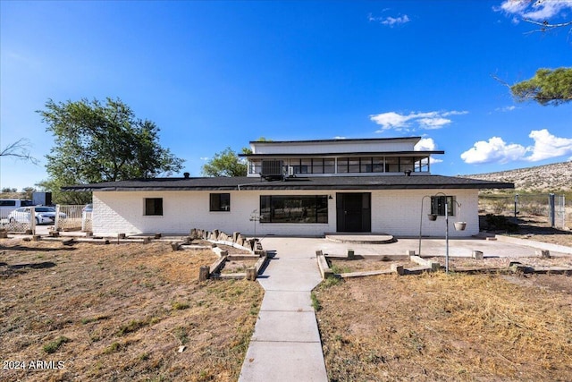 back of property featuring central AC unit and a patio area