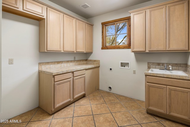 clothes washing area with visible vents, hookup for a washing machine, cabinet space, electric dryer hookup, and a sink