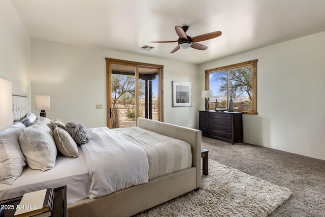 bedroom with access to outside, multiple windows, carpet, and visible vents