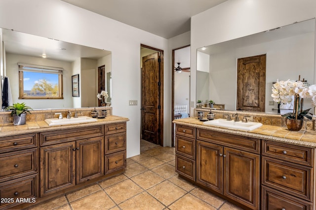 full bathroom with vanity, a ceiling fan, and tile patterned flooring