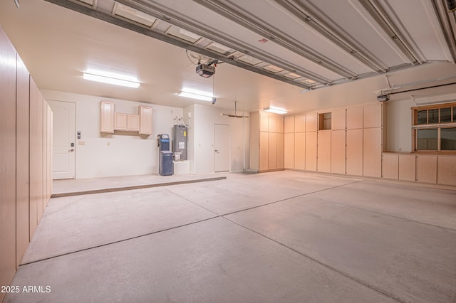 garage featuring electric water heater and a garage door opener