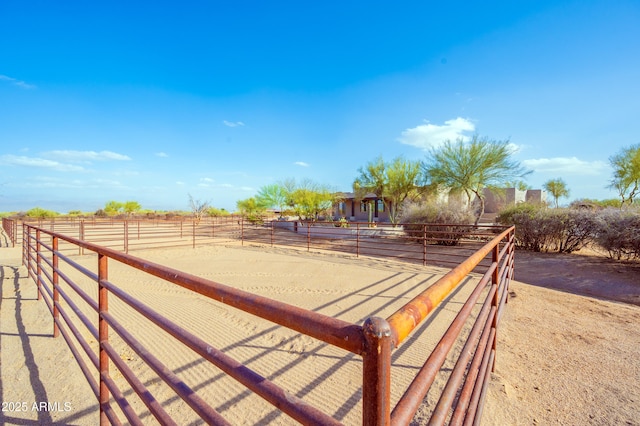 surrounding community featuring an enclosed area and a rural view