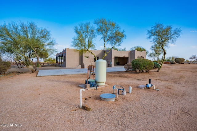 pueblo revival-style home featuring stucco siding