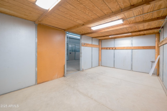 basement featuring wooden ceiling and a garage