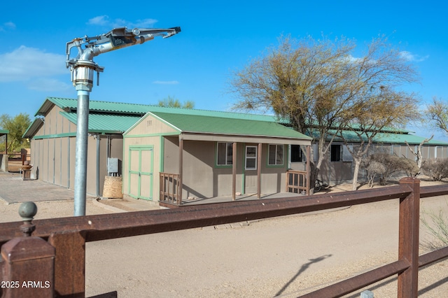 view of front of property with metal roof and an outdoor structure