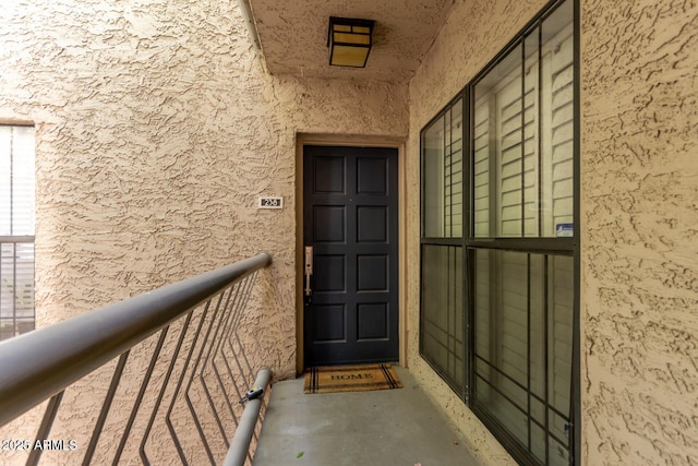 doorway to property with stucco siding