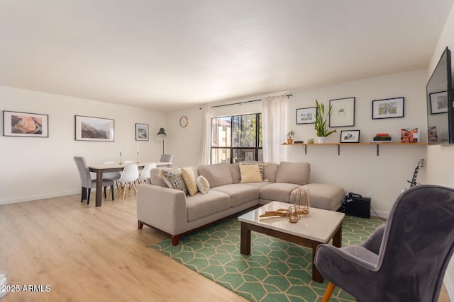 living room featuring wood finished floors and baseboards