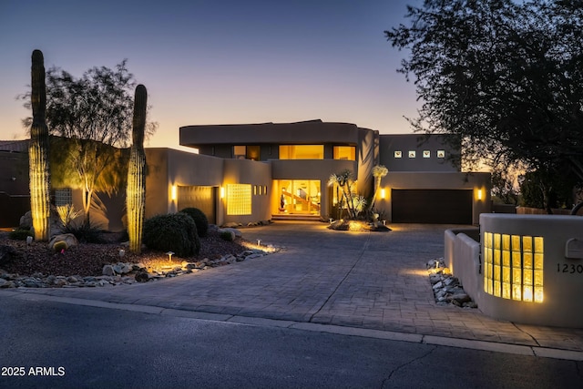 pueblo-style house featuring a garage