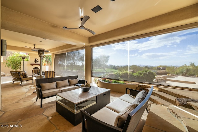 view of patio / terrace featuring an outdoor living space with a fireplace and ceiling fan