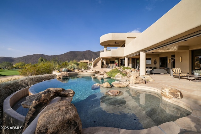 view of swimming pool with a mountain view and a patio