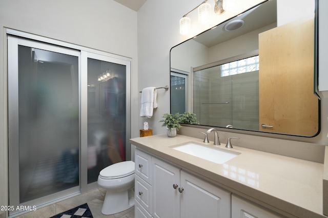 bathroom with tile patterned floors, vanity, toilet, and a shower with door