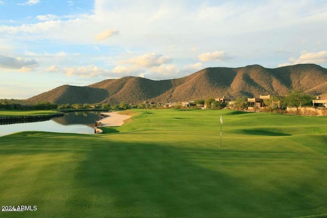 view of community with a water and mountain view and a lawn