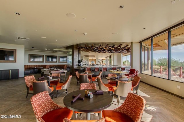 dining space featuring parquet floors