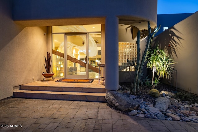 entrance to property featuring a patio