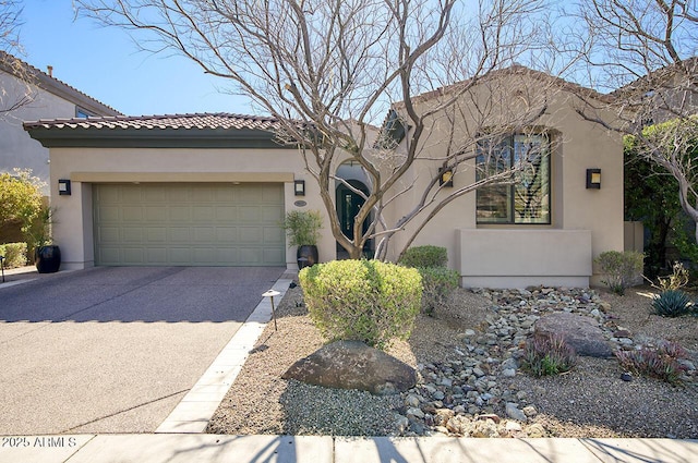 mediterranean / spanish home featuring a garage, concrete driveway, and stucco siding