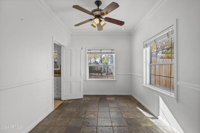 spare room featuring crown molding, plenty of natural light, and ceiling fan