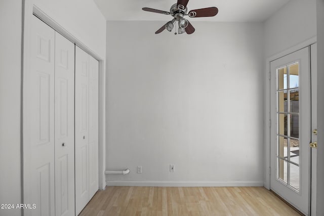 unfurnished bedroom with ceiling fan, a closet, and light wood-type flooring