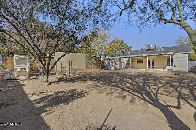 rear view of property featuring french doors and central AC