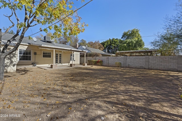 rear view of house featuring french doors, a patio, and central AC