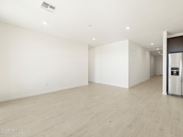 empty room with light hardwood / wood-style flooring