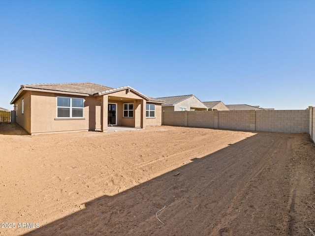 rear view of property featuring a patio