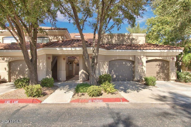 mediterranean / spanish home with a garage