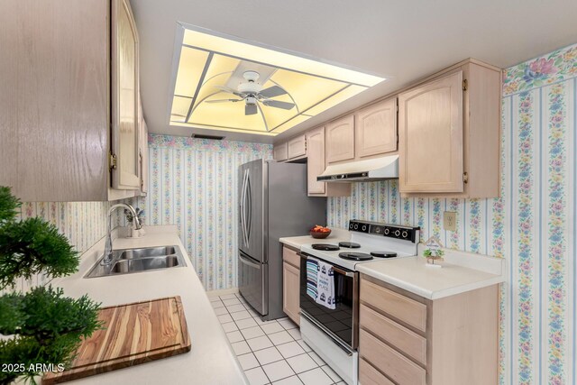 2442 N 22nd Ave, Phoenix, AZ 85009 - kitchen with white electric range, a sink, under cabinet range hood, light countertops, and wallpapered walls