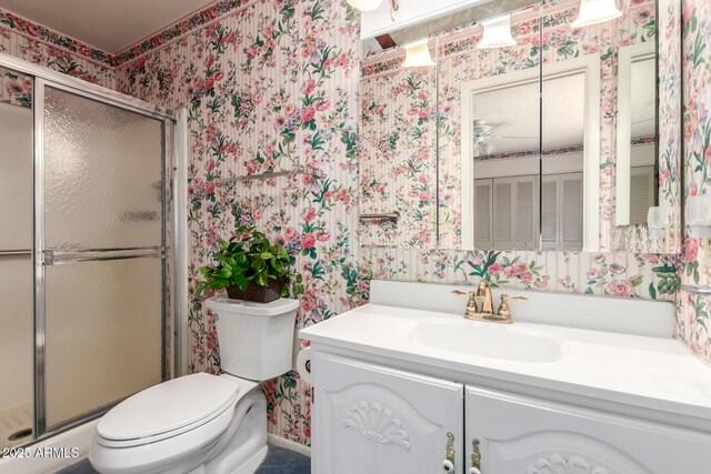 2442 N 22nd Ave, Phoenix, AZ 85009 - bathroom with wallpapered walls, toilet, vanity, and a stall shower