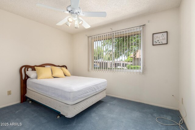 2442 N 22nd Ave, Phoenix, AZ 85009 - carpeted bedroom with ceiling fan, a textured ceiling, and baseboards