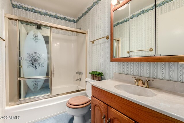 2442 N 22nd Ave, Phoenix, AZ 85009 - bathroom featuring wallpapered walls, combined bath / shower with glass door, vanity, and toilet
