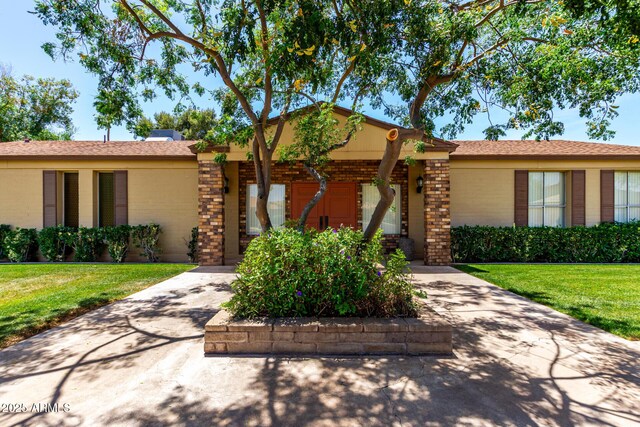 2442 N 22nd Ave, Phoenix, AZ 85009 - view of front of home featuring a front lawn and brick siding