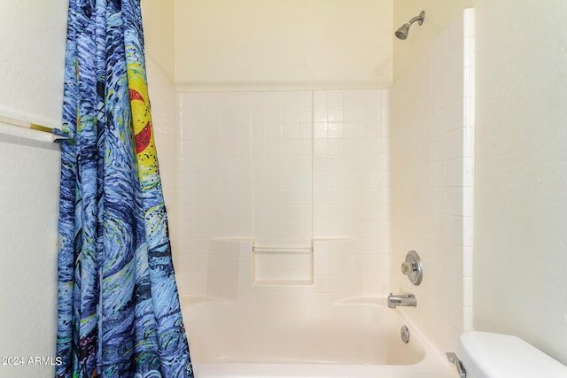 bathroom featuring toilet and shower / tub combo