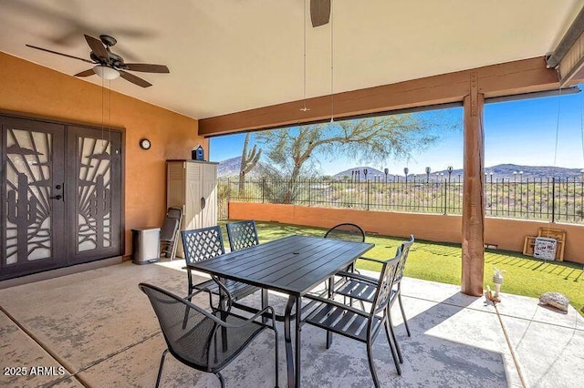 44421 N 12th St, New River, AZ 85087 - view of patio / terrace with outdoor dining area, a ceiling fan, french doors, and a mountain view