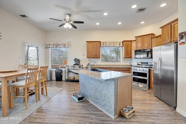 44421 N 12th St, New River, AZ 85087 - kitchen featuring appliances with stainless steel finishes, a sink, ceiling fan, an island with sink, and recessed lighting