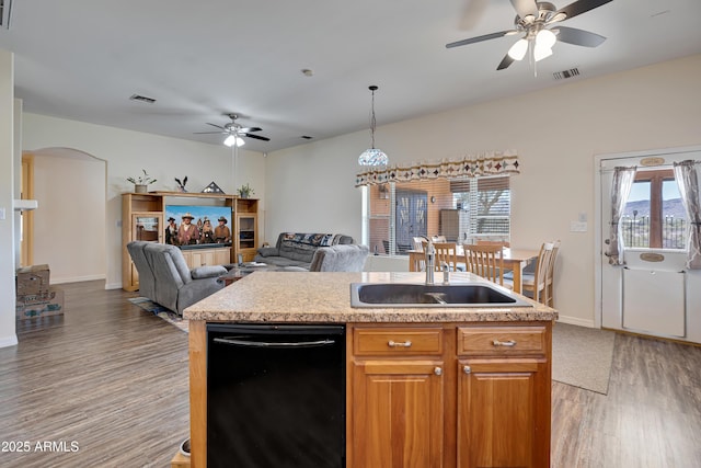 44421 N 12th St, New River, AZ 85087 - kitchen with a ceiling fan, black dishwasher, light wood-type flooring, a sink, and healthy amount of natural light