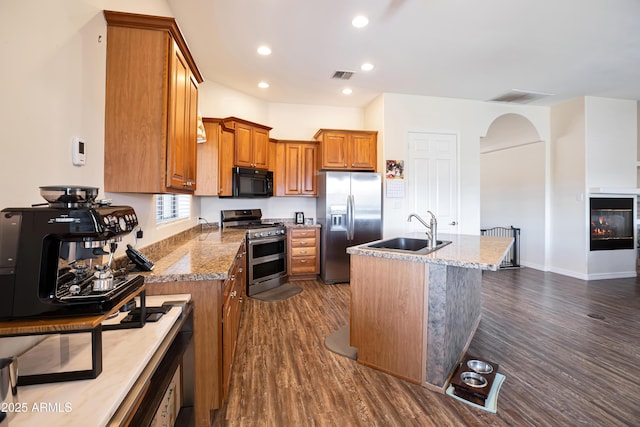 44421 N 12th St, New River, AZ 85087 - kitchen featuring stainless steel appliances, a sink, brown cabinetry, dark wood finished floors, and recessed lighting