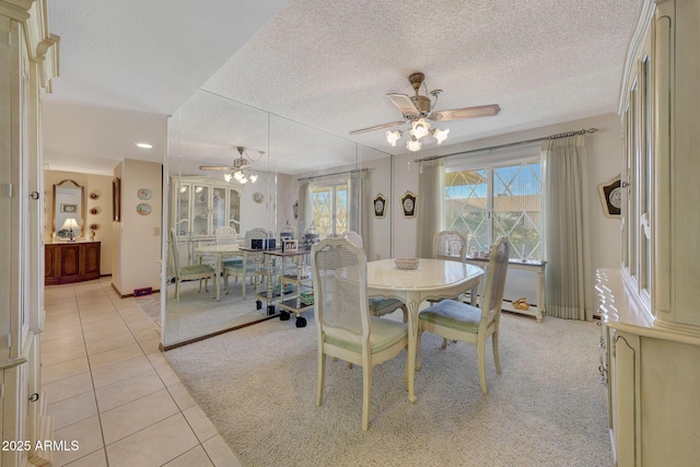 dining area featuring light tile patterned flooring, ceiling fan, plenty of natural light, and a textured ceiling