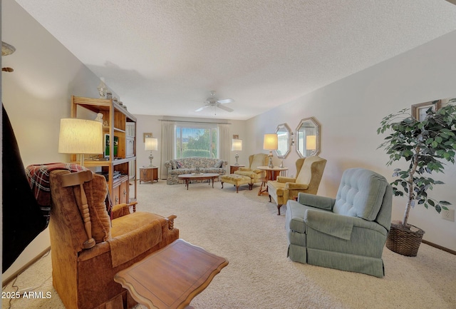 carpeted living room with ceiling fan and a textured ceiling