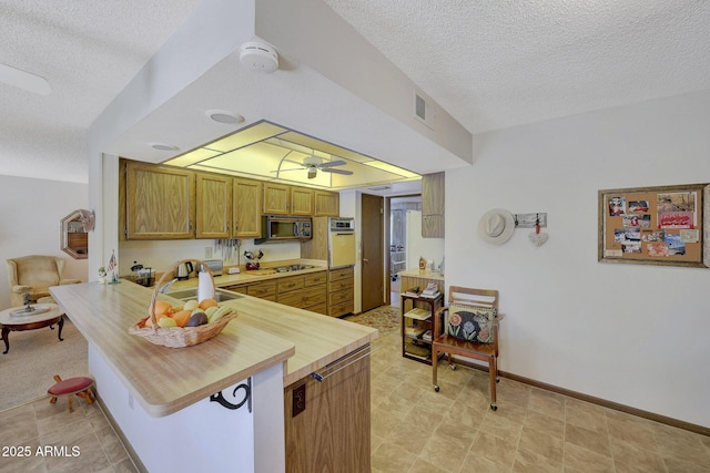 kitchen with sink, ceiling fan, wall oven, black gas stovetop, and kitchen peninsula