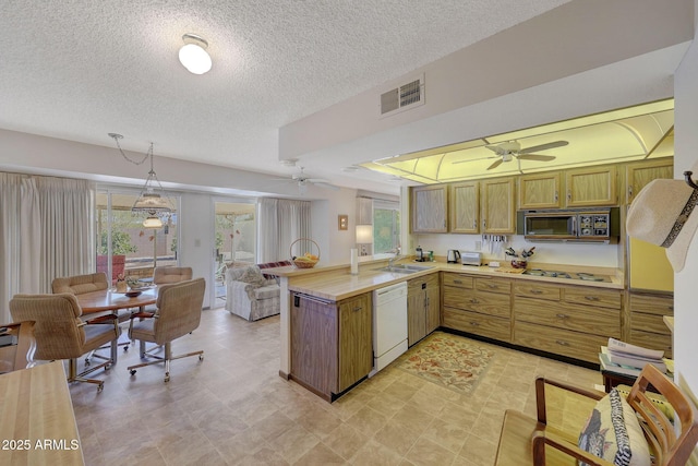 kitchen with dishwasher, sink, hanging light fixtures, ceiling fan, and kitchen peninsula