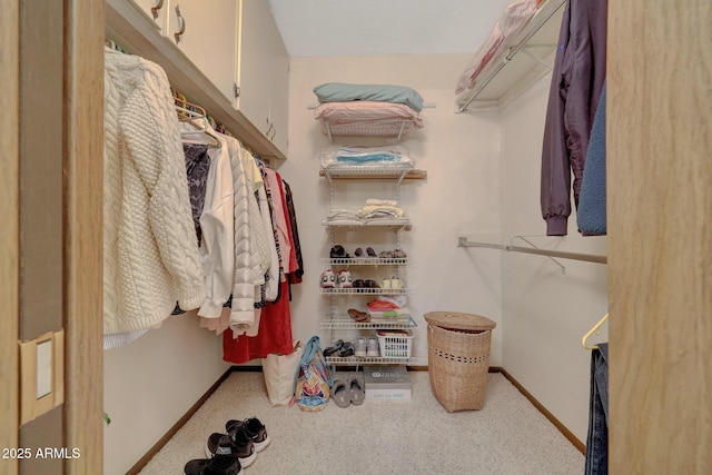 walk in closet featuring carpet flooring