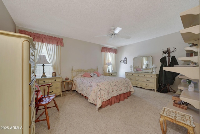 carpeted bedroom with ceiling fan and a textured ceiling