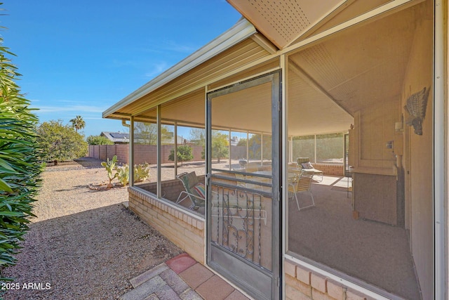 view of exterior entry with a patio