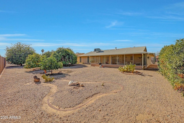 rear view of property with a sunroom