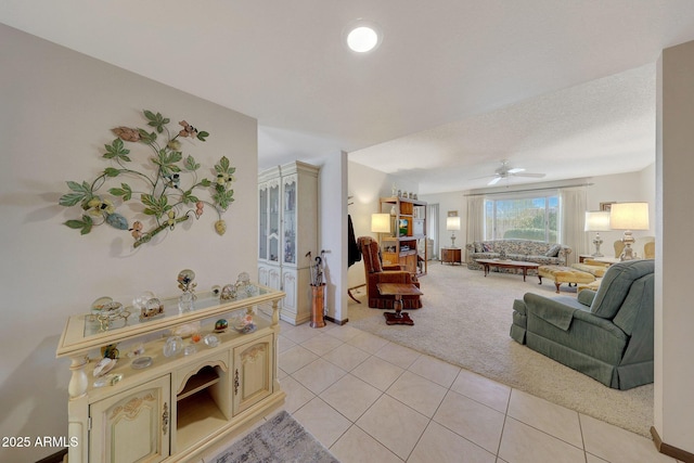 living room featuring ceiling fan and light carpet