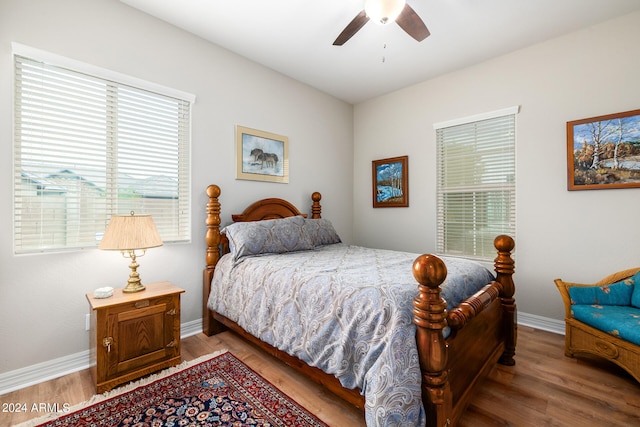 bedroom with ceiling fan and hardwood / wood-style flooring