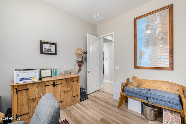 home office with light hardwood / wood-style flooring